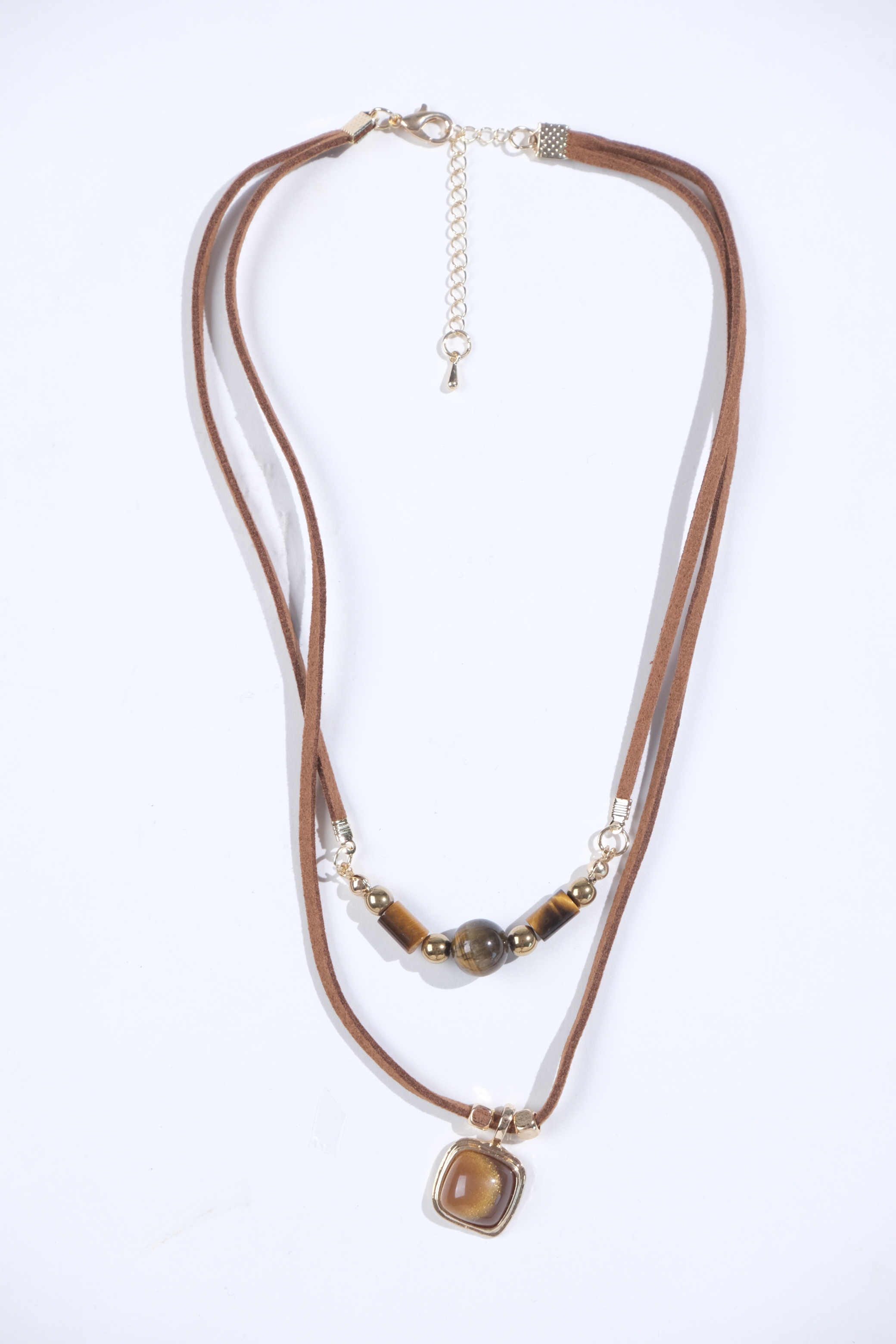 Brown cord layered necklace with bead and pendant details